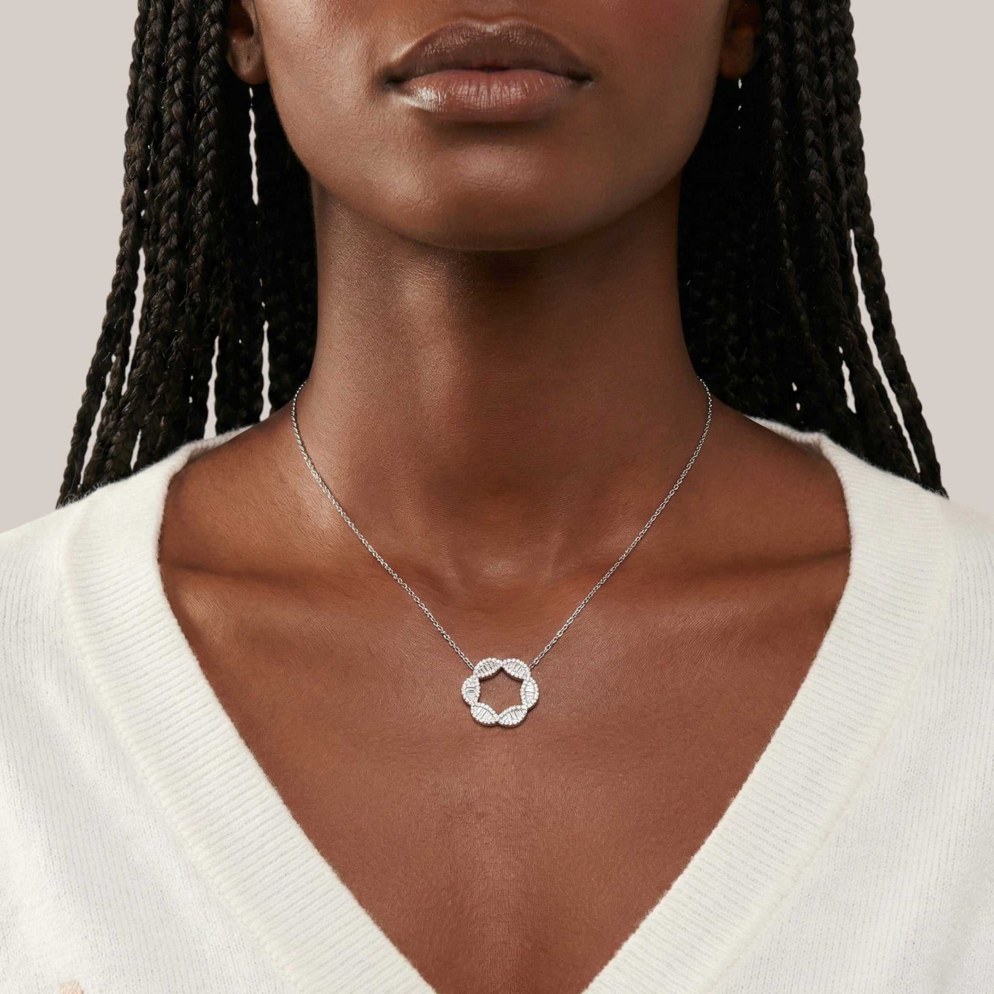 Marise Moissanite Necklace with circular pendant and 925 sterling silver chain worn on model's neck
