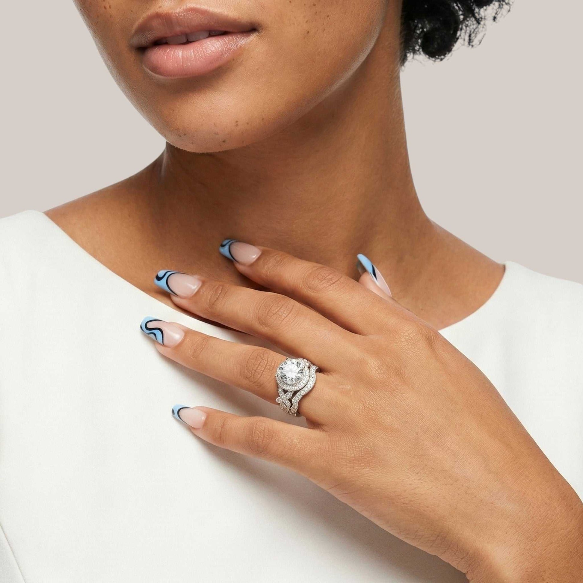 Close-up of a hand wearing a diamond ring with a neutral background