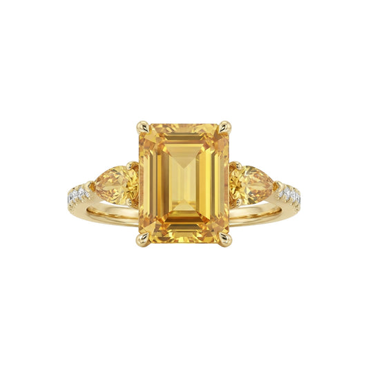 Gold ring with a large yellow gemstone and smaller stones on a white background