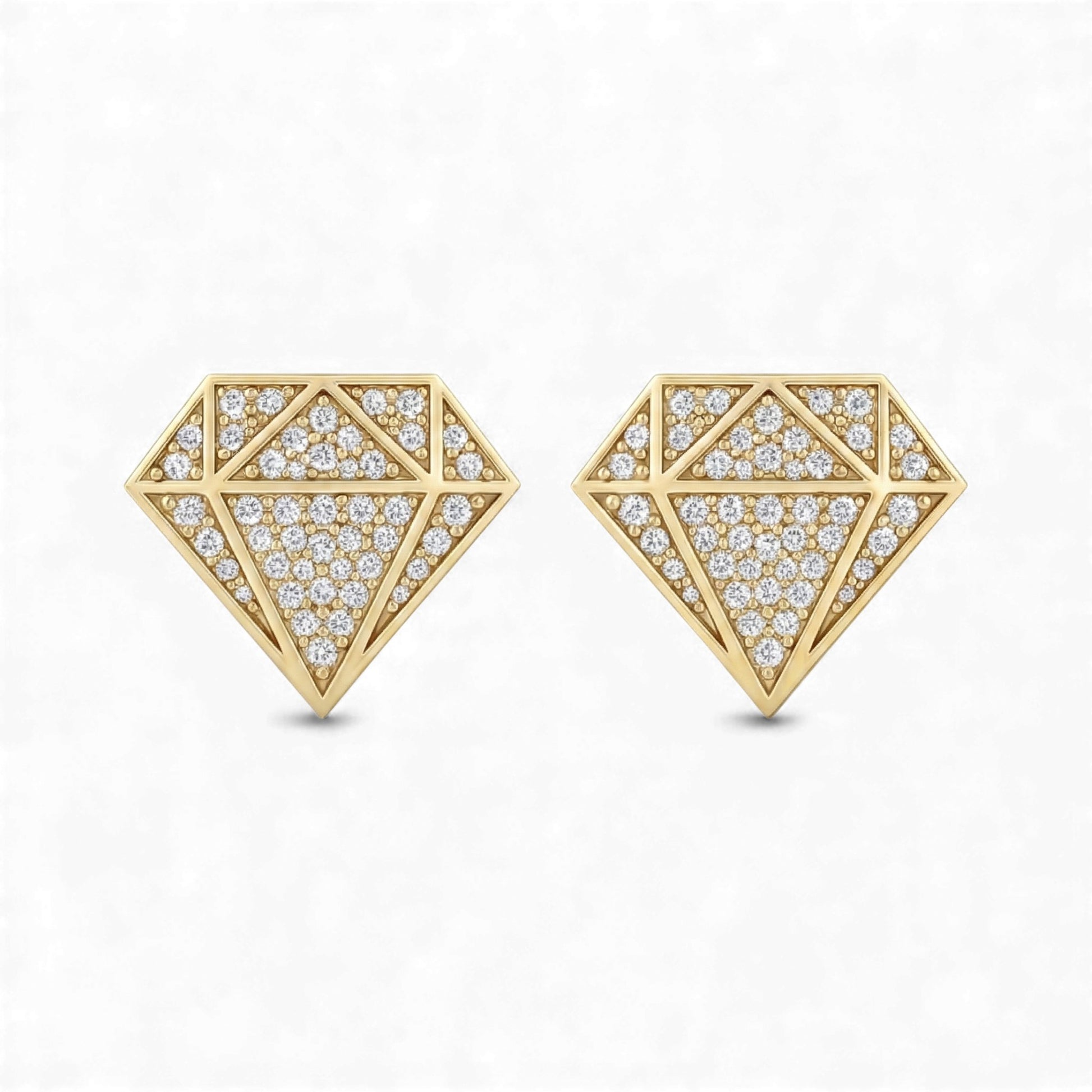 Gold geometric earrings with diamond-like stones on a white background