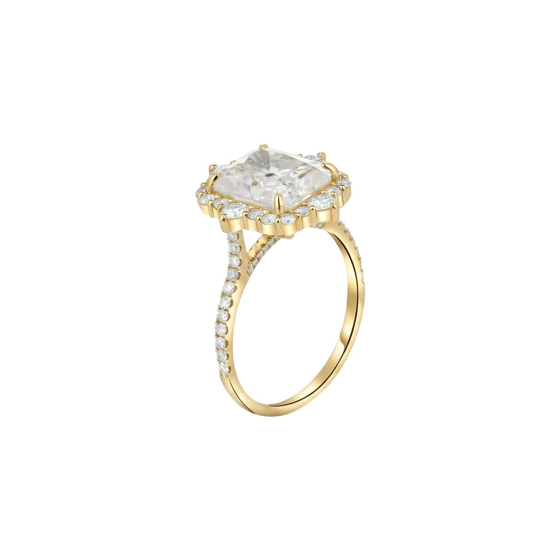 Gold ring with a large central diamond and smaller diamonds on the band against a white background