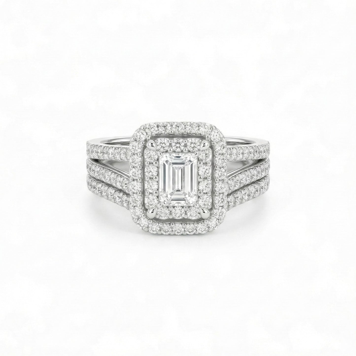 Diamond ring with emerald-cut center stone on a white background