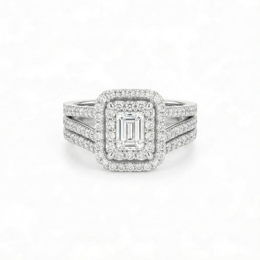 Diamond ring with emerald-cut center stone on a white background