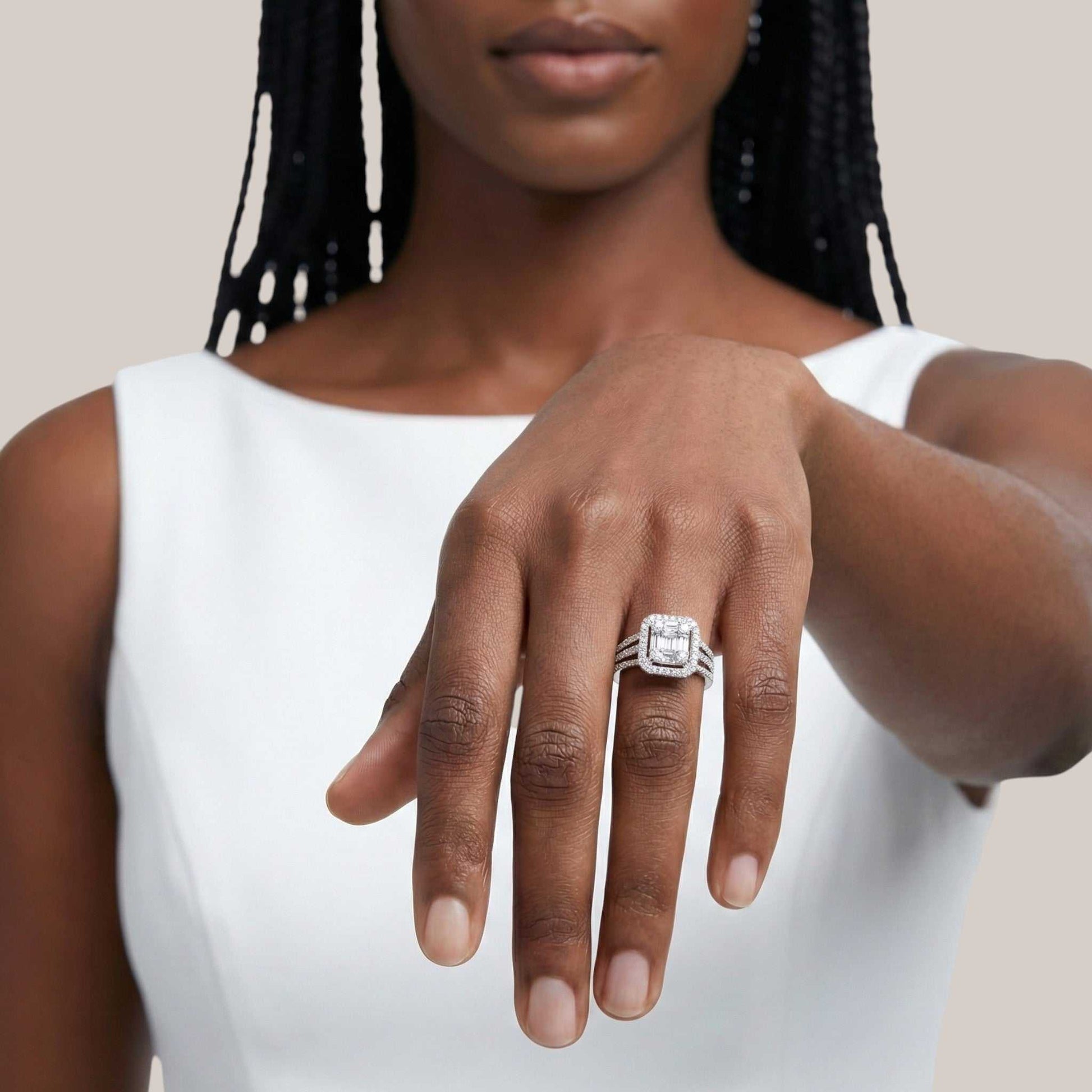 Woman wearing a silver ring with a diamond on a neutral background