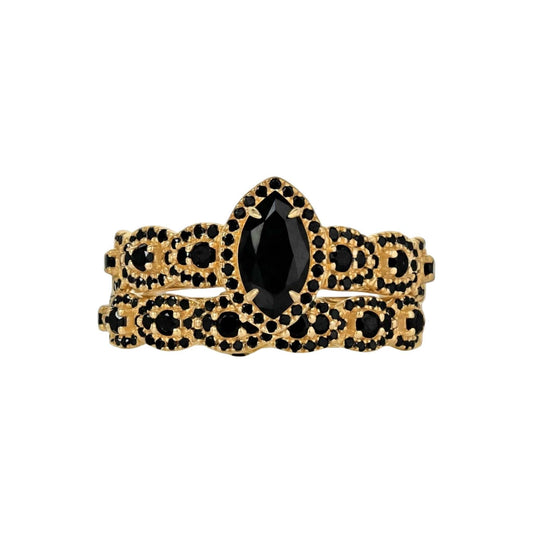 Gold bracelet with black gemstones on a white background