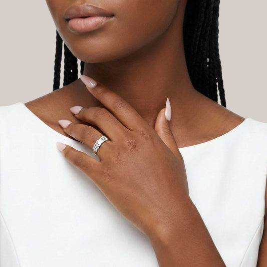 Close-up of a woman's hand wearing a ring with a white background