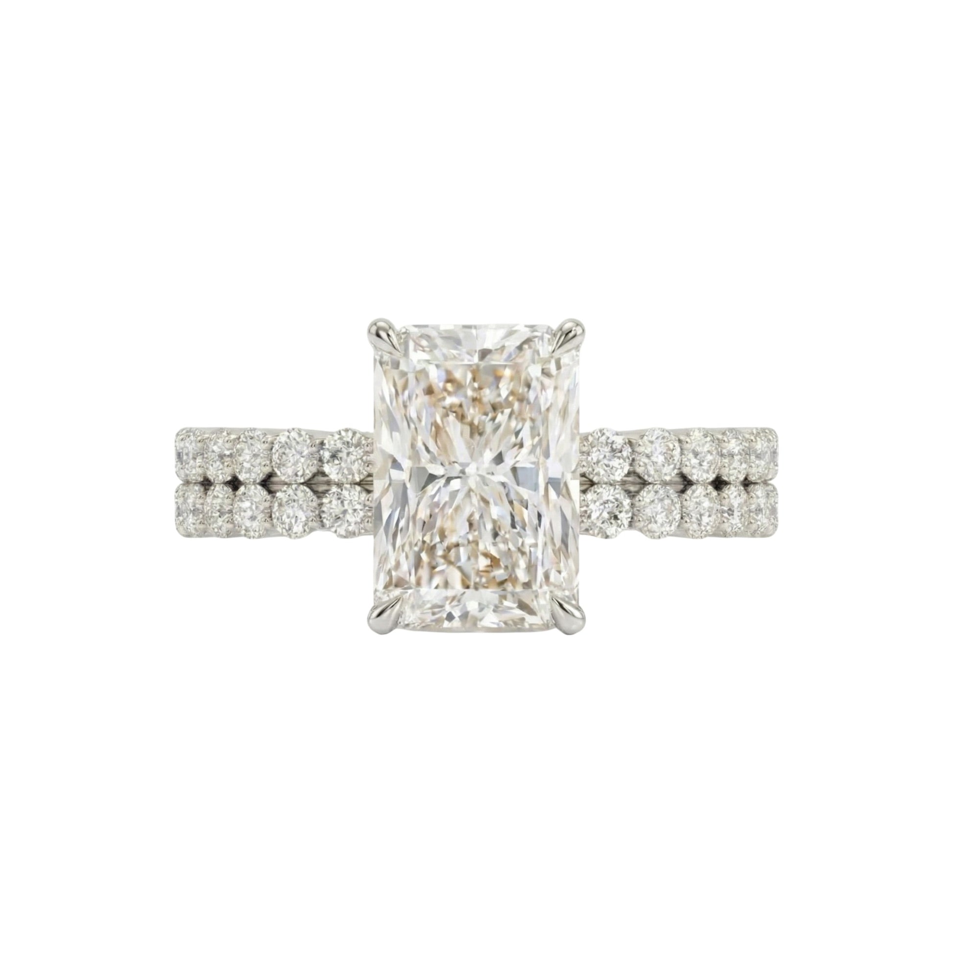 Diamond ring with a rectangular center stone on a white background