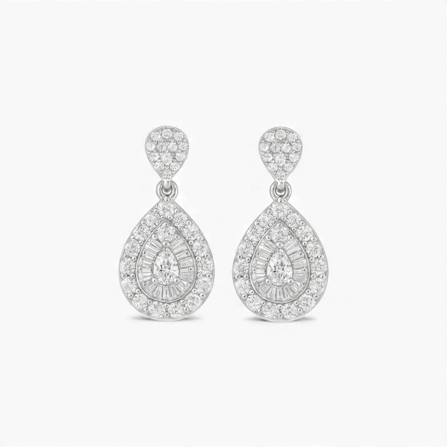 Pair of silver teardrop earrings with clear gemstones on a white background