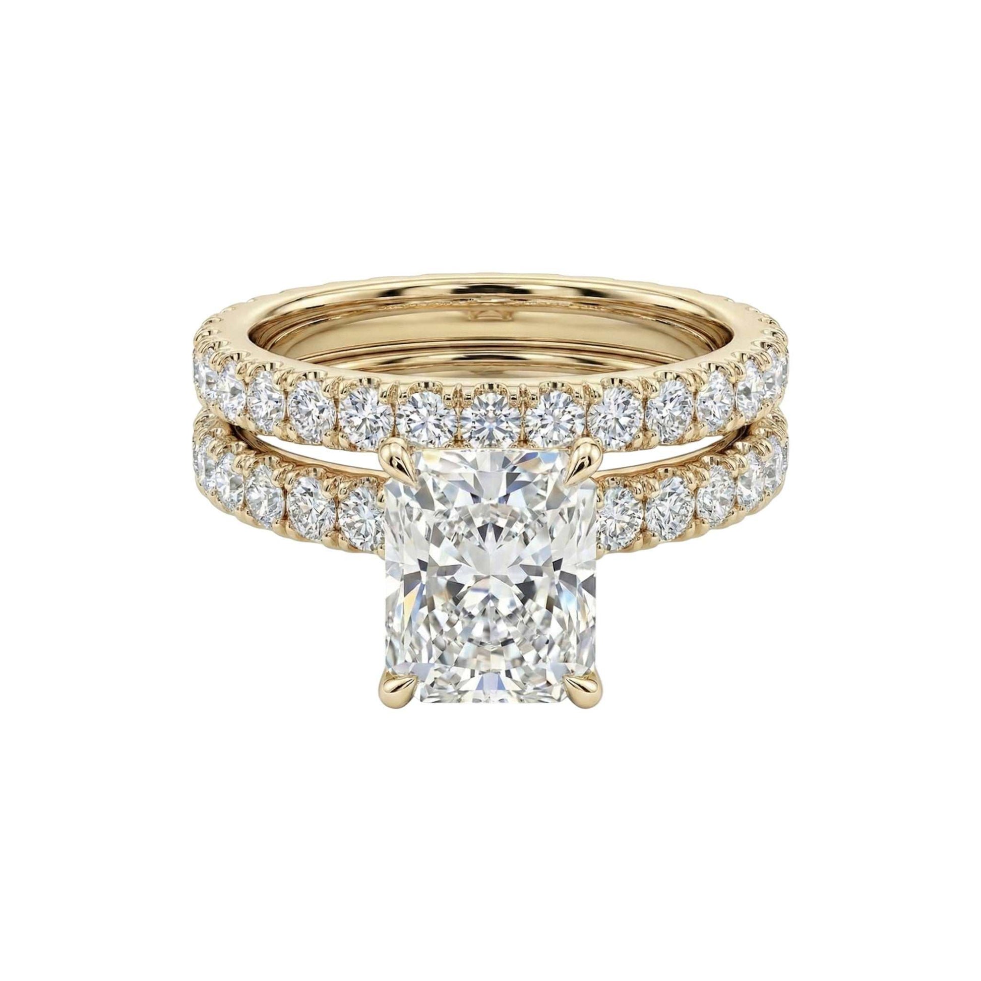 Gold ring with a large diamond and smaller diamonds on a white background