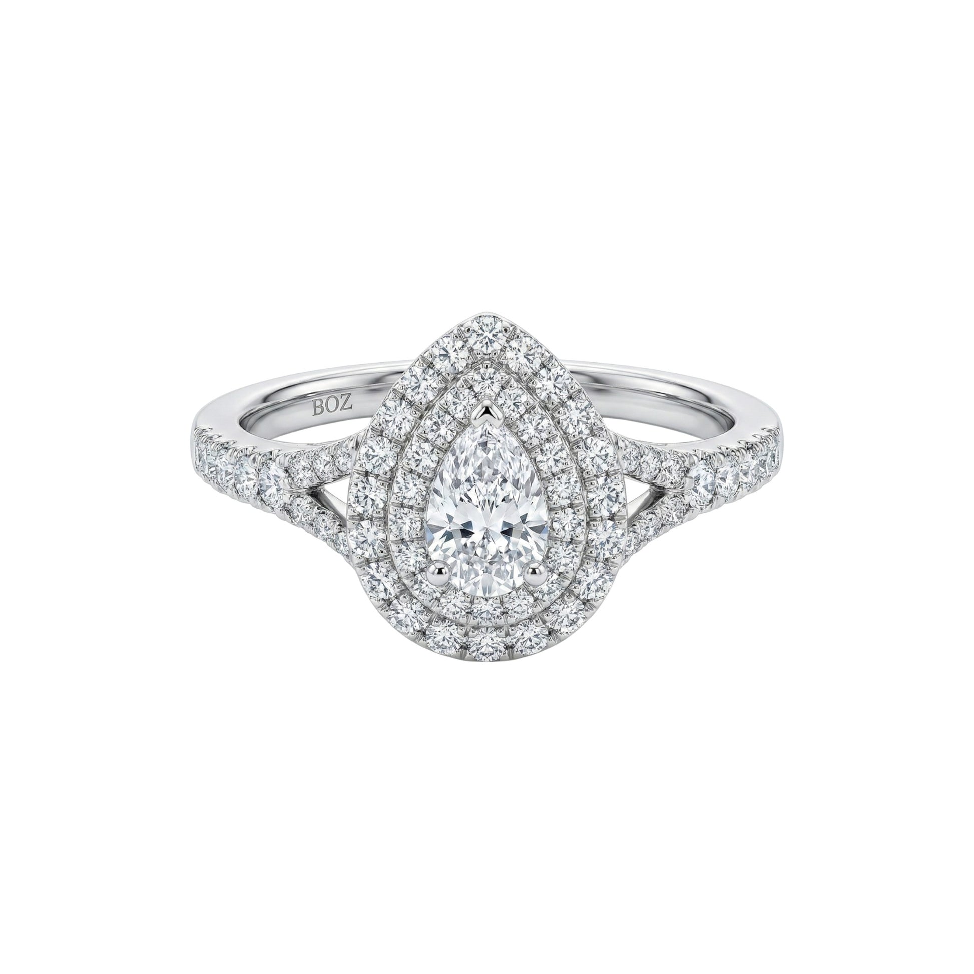 Diamond ring with a pear-shaped center stone on a white background