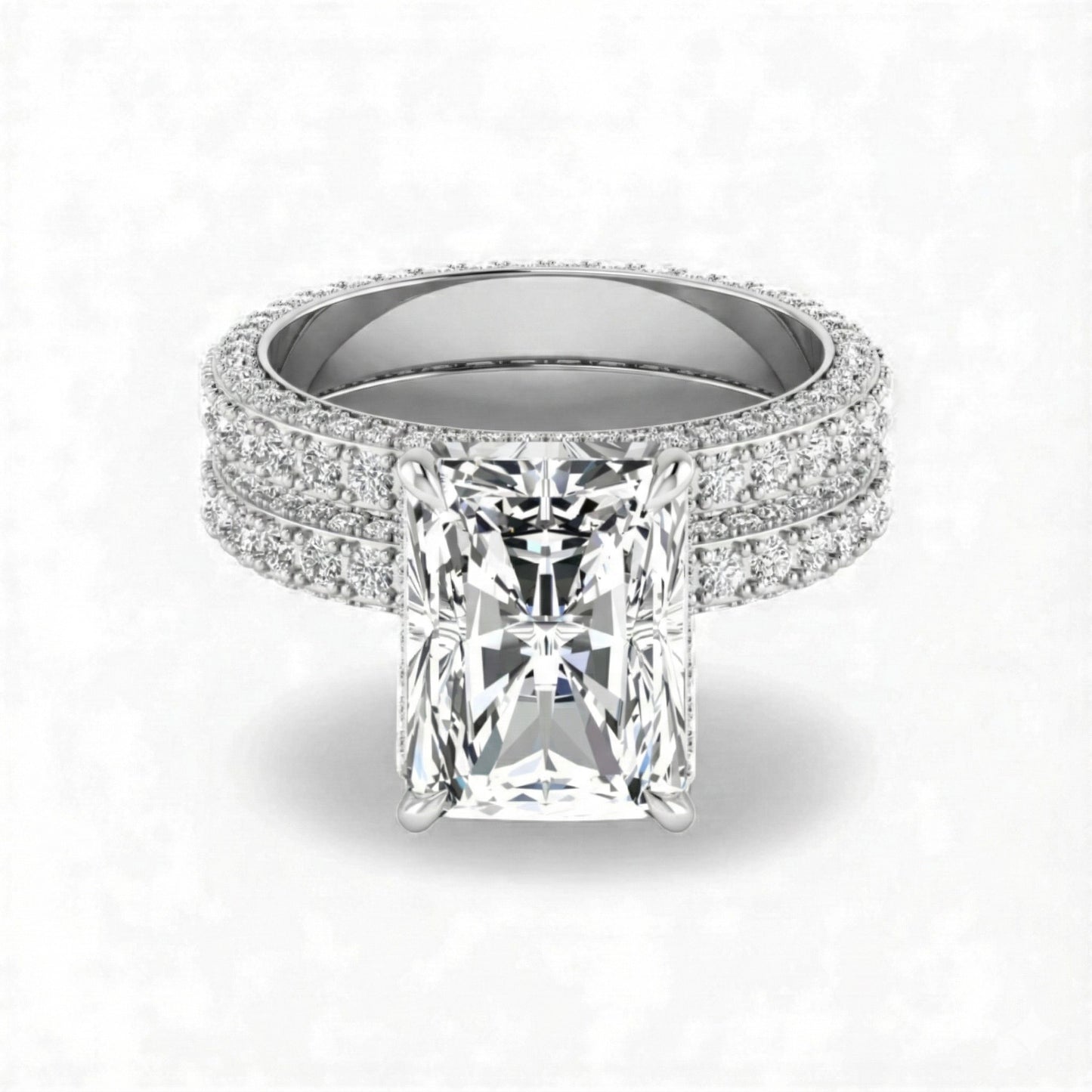 Silver ring with a large diamond and smaller diamonds on the band against a white background