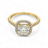 Gold ring with a large diamond and smaller diamonds on the band against a white background
