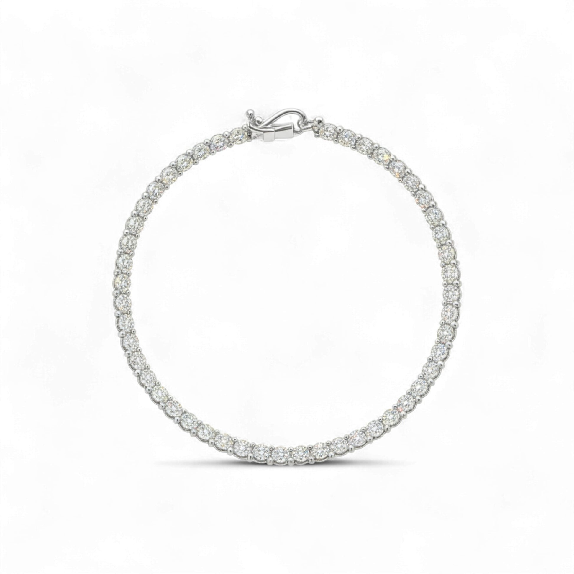 Silver bracelet with clear stones on a white background