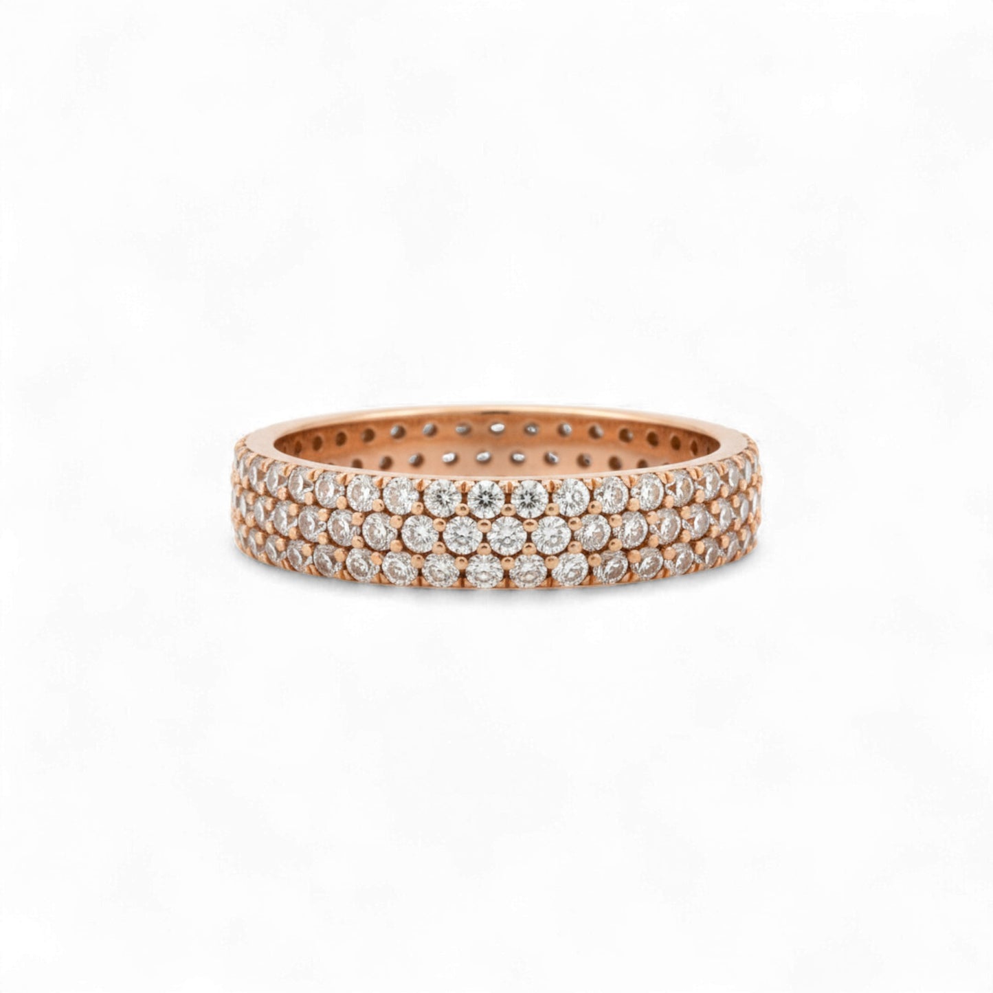Rose gold ring with embedded diamonds on a white background