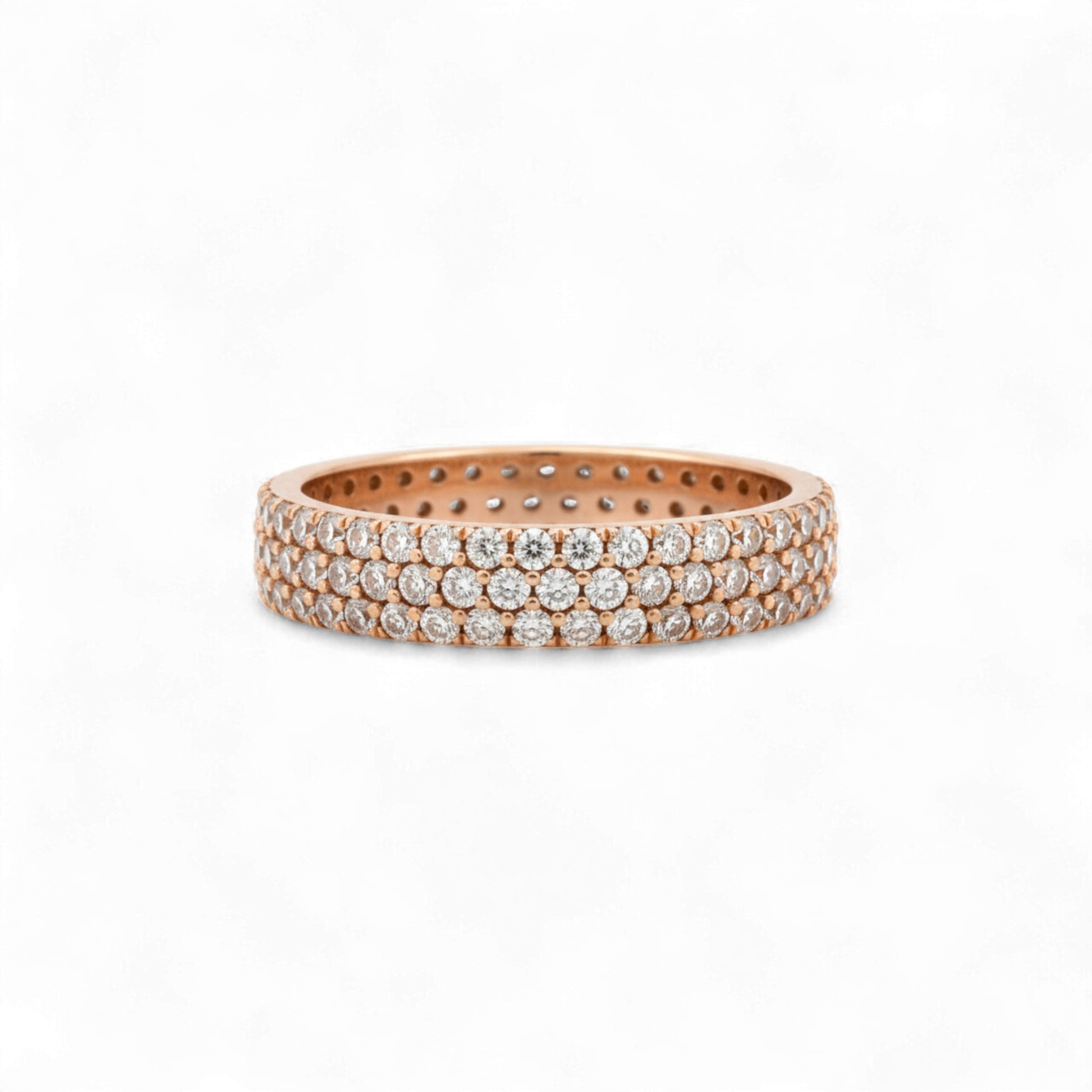 Rose gold ring with embedded diamonds on a white background