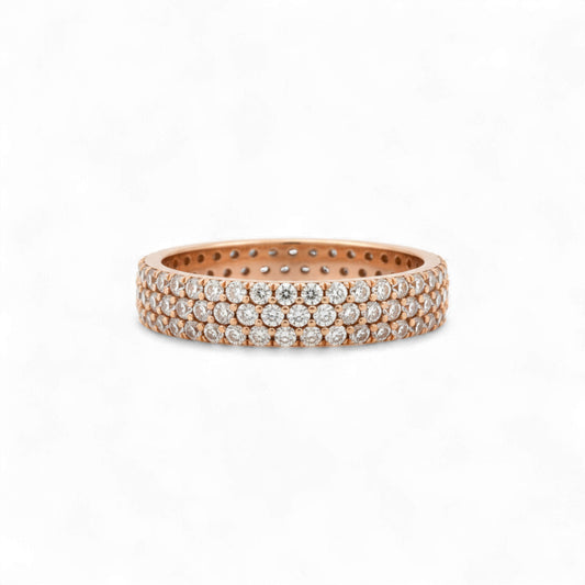 Rose gold ring with embedded diamonds on a white background