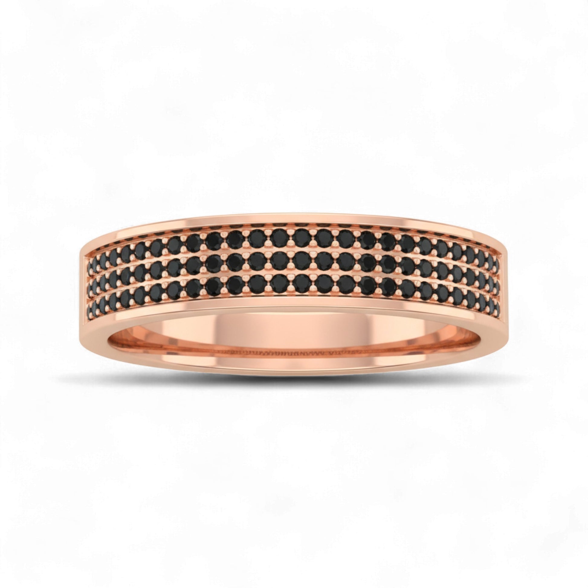 Rose gold ring with black gemstones on a white background