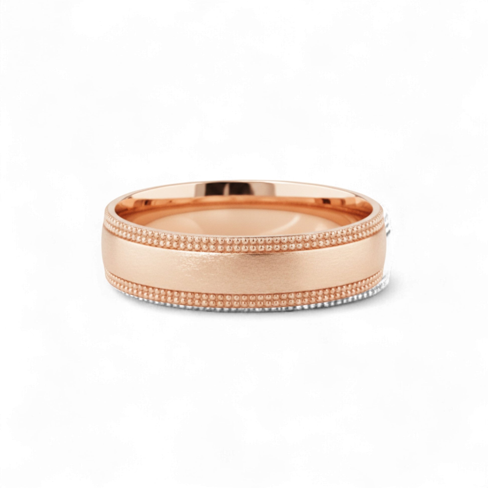 Rose gold ring with beaded design on a white background