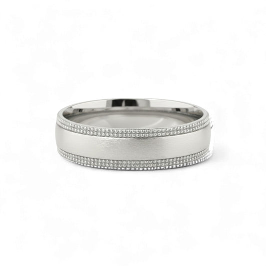 Silver ring with beaded design on a white background