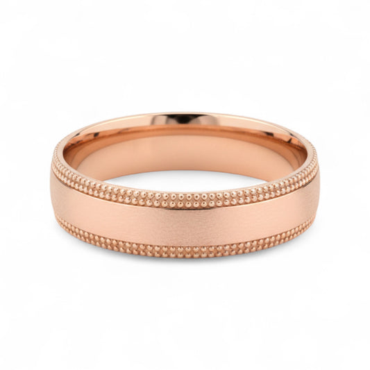 Rose gold ring with textured band on a white background