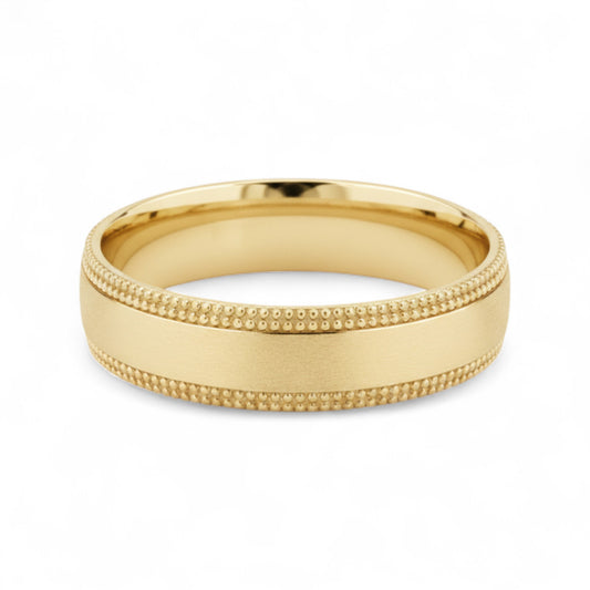 Gold ring with textured design on a white background