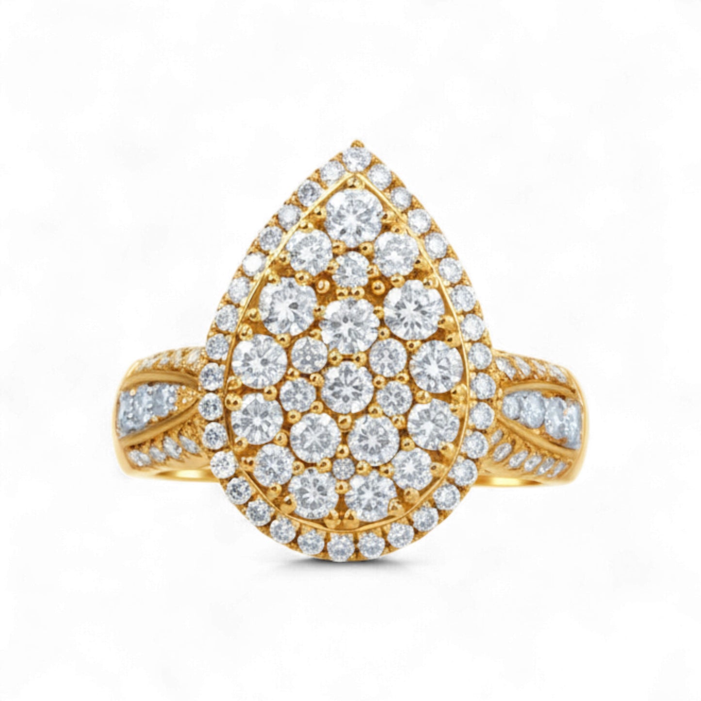 Gold ring with diamond teardrop design on a white background