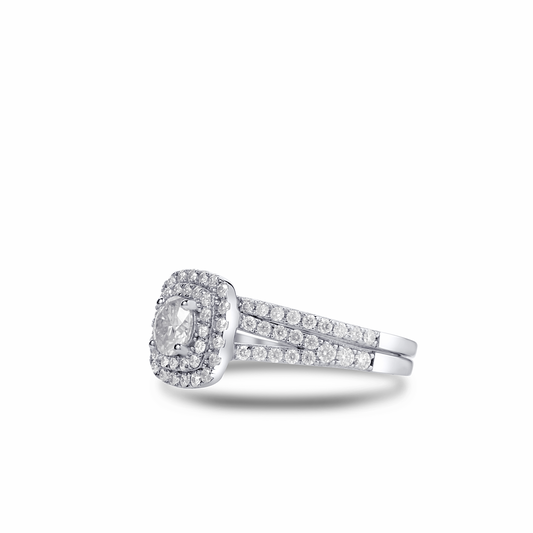 Diamond ring with a halo and side stones on a white background