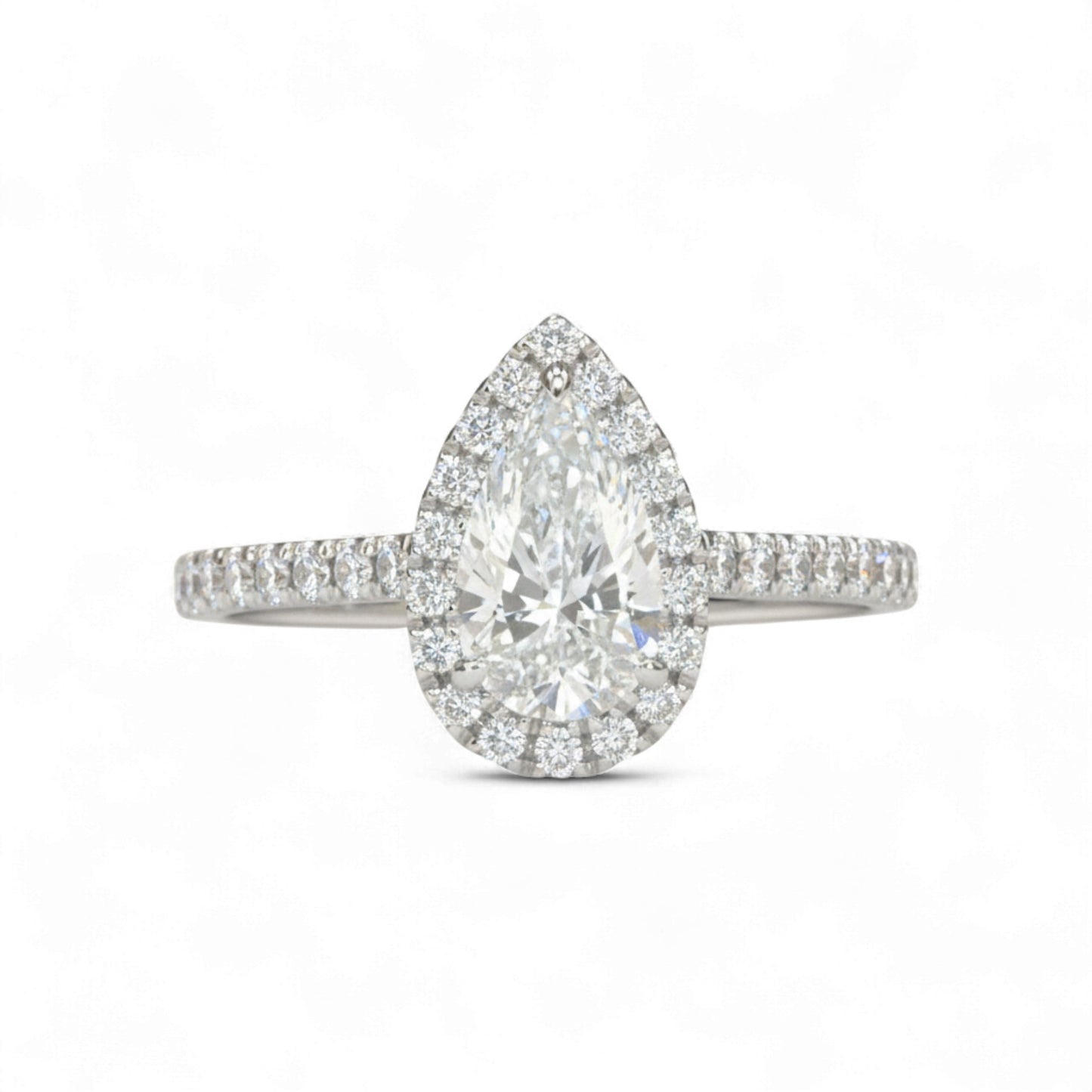Diamond ring with pear-shaped center stone on a white background