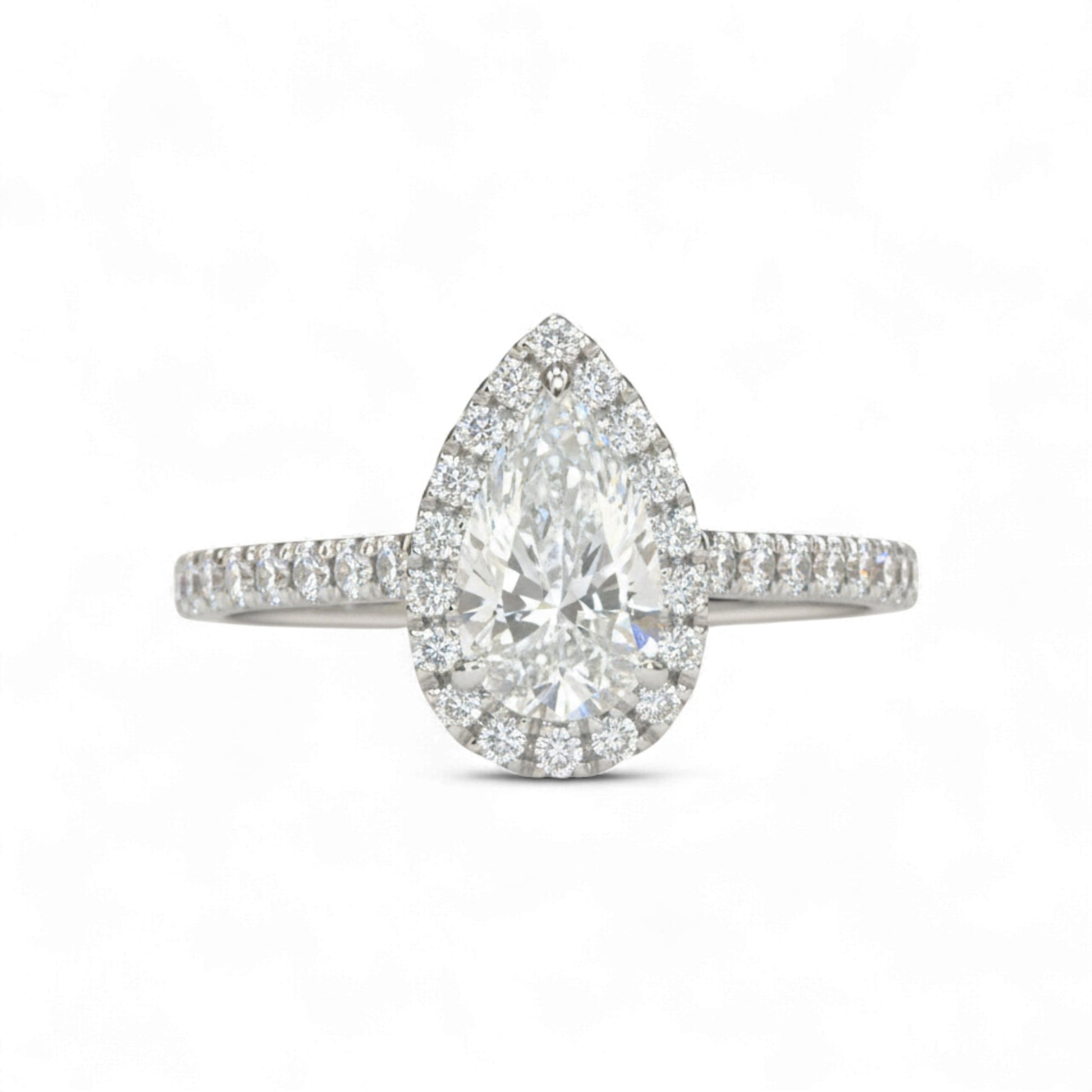 Diamond ring with pear-shaped center stone on a white background
