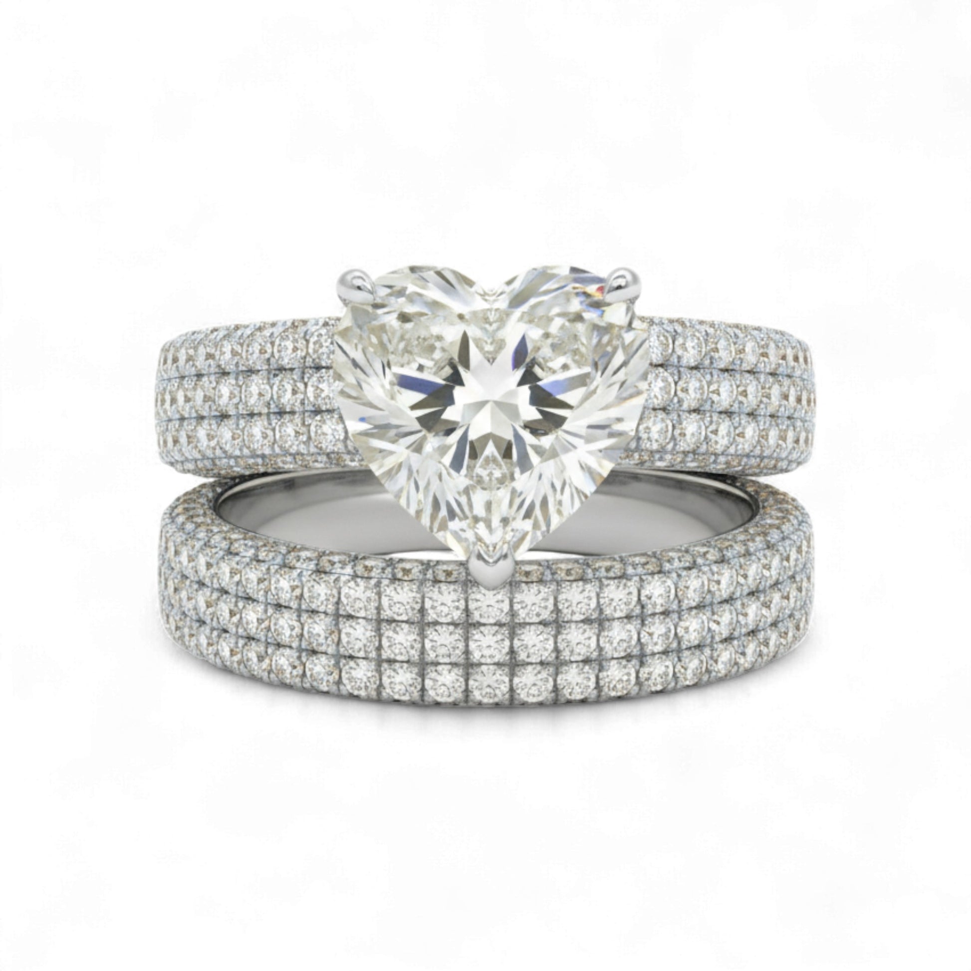 Set of diamond rings with a heart-shaped center stone on a white background