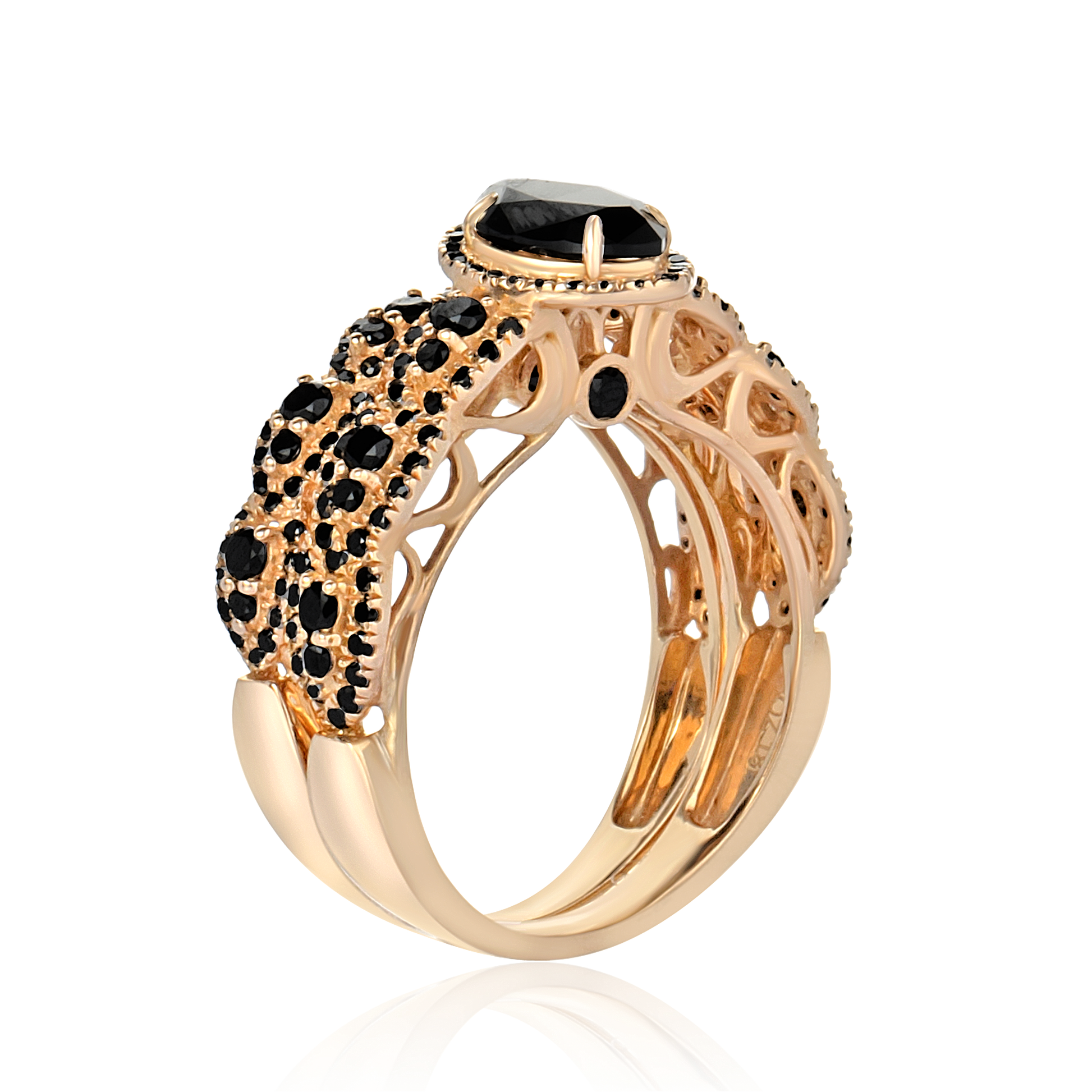 Rose gold ring with black gemstones on a white background