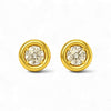 Gold earrings with round gemstones on a white background