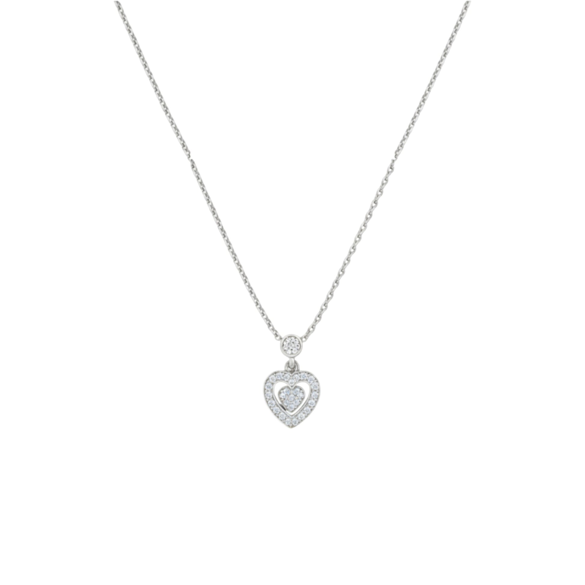 Silver necklace with a heart-shaped pendant on a white background