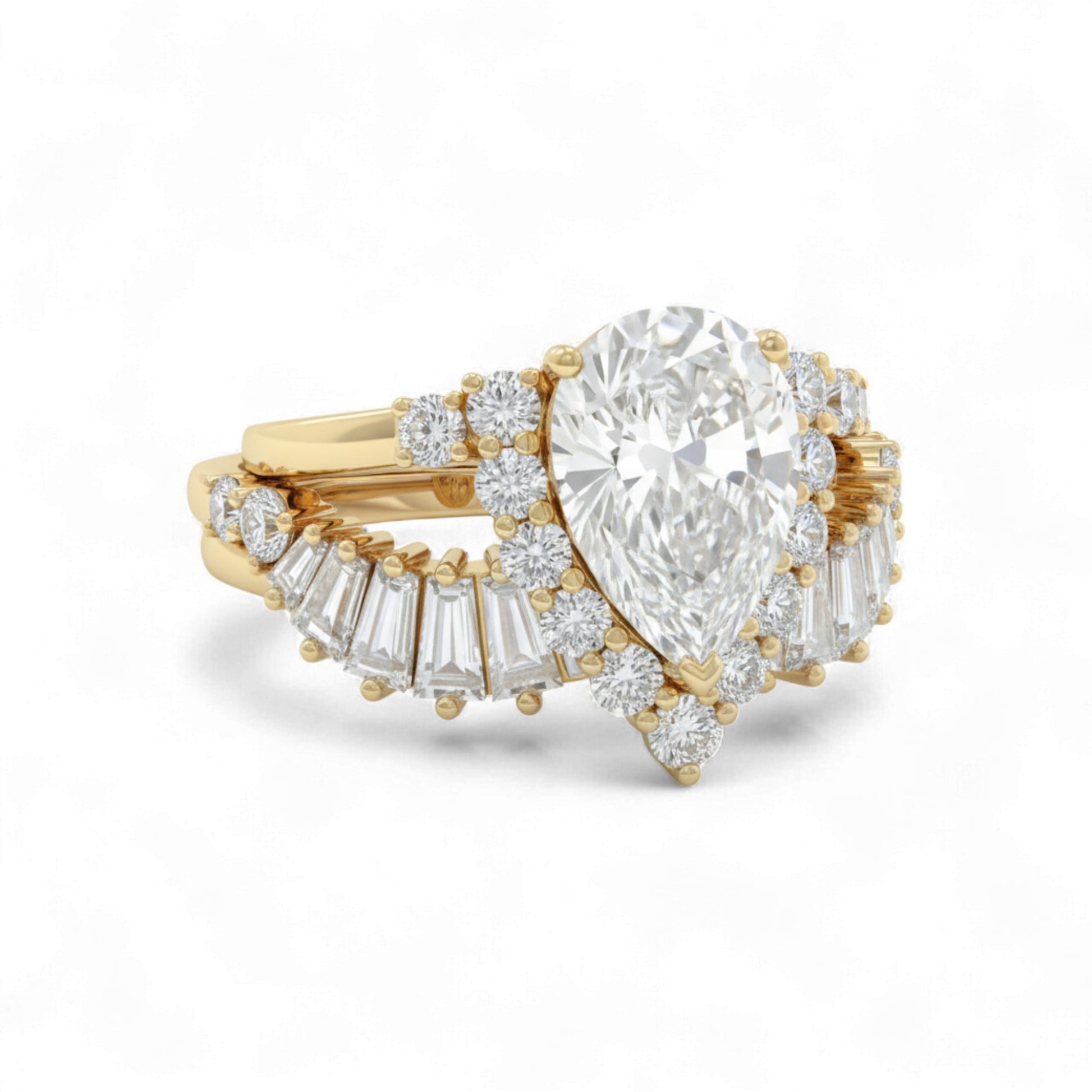Gold ring with a pear-shaped diamond and smaller baguette diamonds on a white background