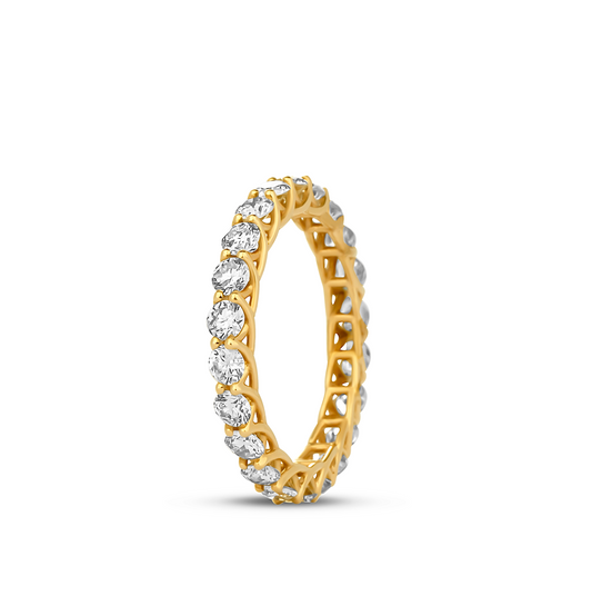 A gold band ring with a geometric pattern and multiple diamonds set around its circumference.