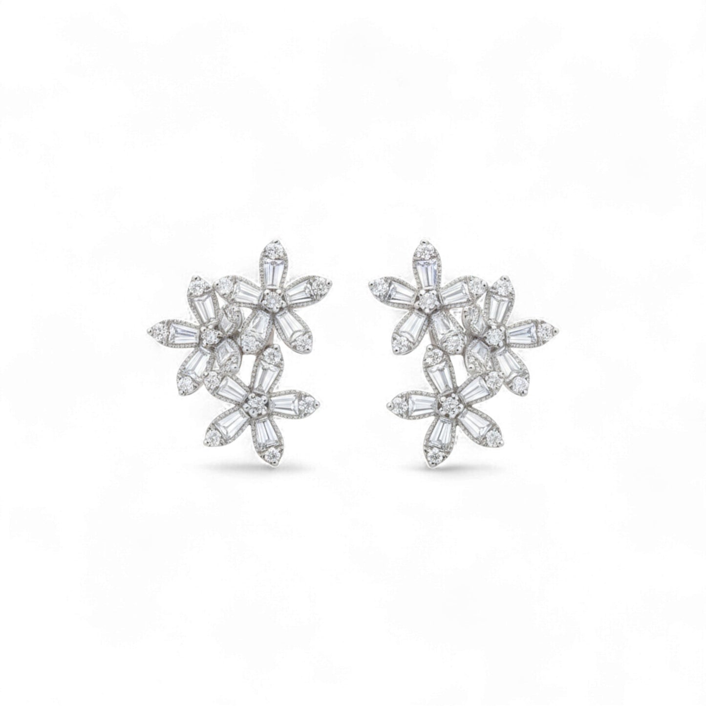 Pair of diamond flower earrings on a white background