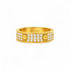 Gold ring with diamond accents on a white background