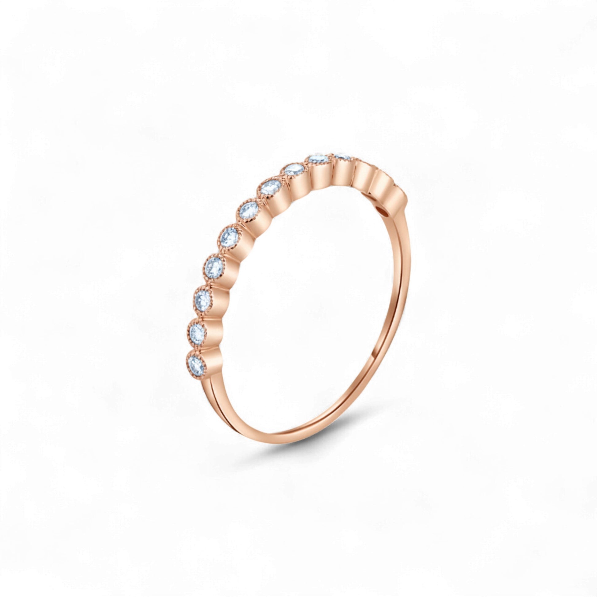 Rose gold ring with small diamonds on a white background