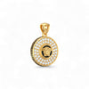 Gold pendant with a black and gold emblem on a white background