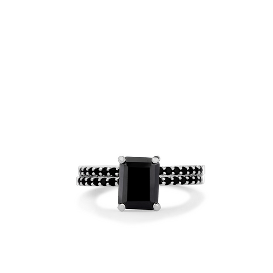 Ring with a black gemstone and black band on a white background