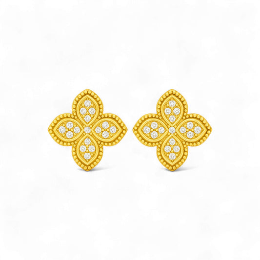 Gold butterfly earrings with diamond-like stones on a white background