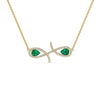 An 18K gold necklace with a infinity symbol design featuring green center stones and diamond accents.