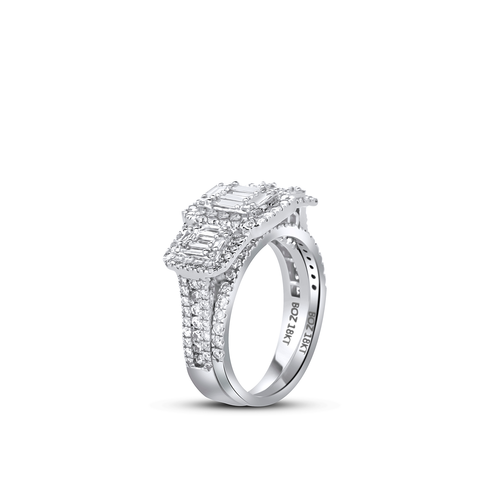 Diamond ring with emerald-cut center stone on a white background