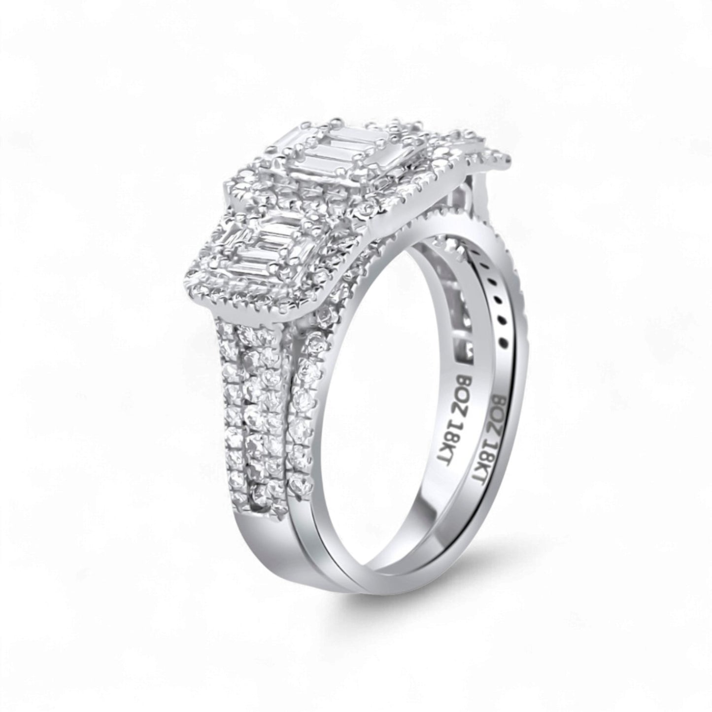 Diamond ring with emerald-cut center stone on a white background
