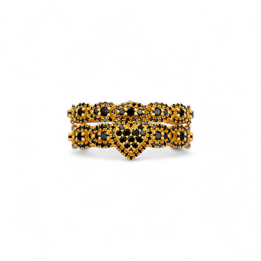 Gold and black gemstone ring on a white background