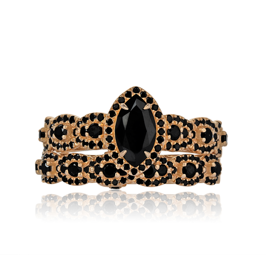 Gold bracelet with black gemstones on a white background