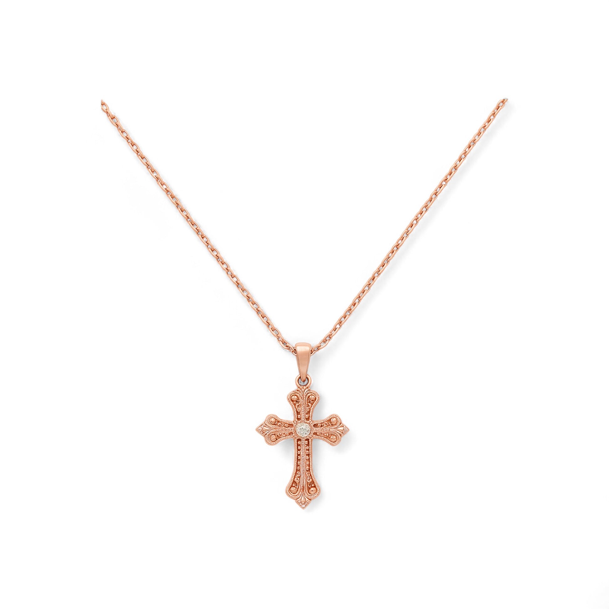 Rose gold cross necklace on a white background