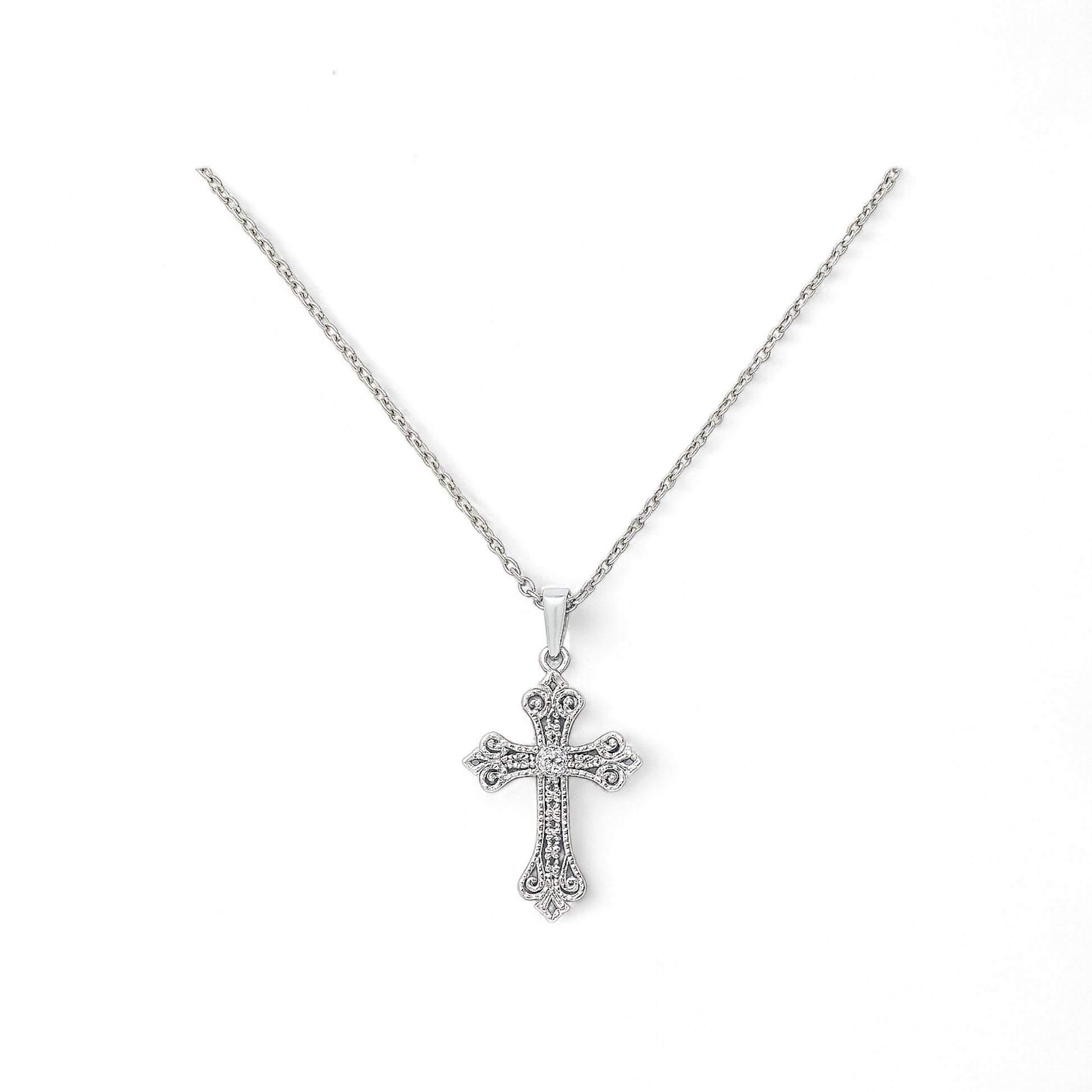 Silver cross necklace on a white background