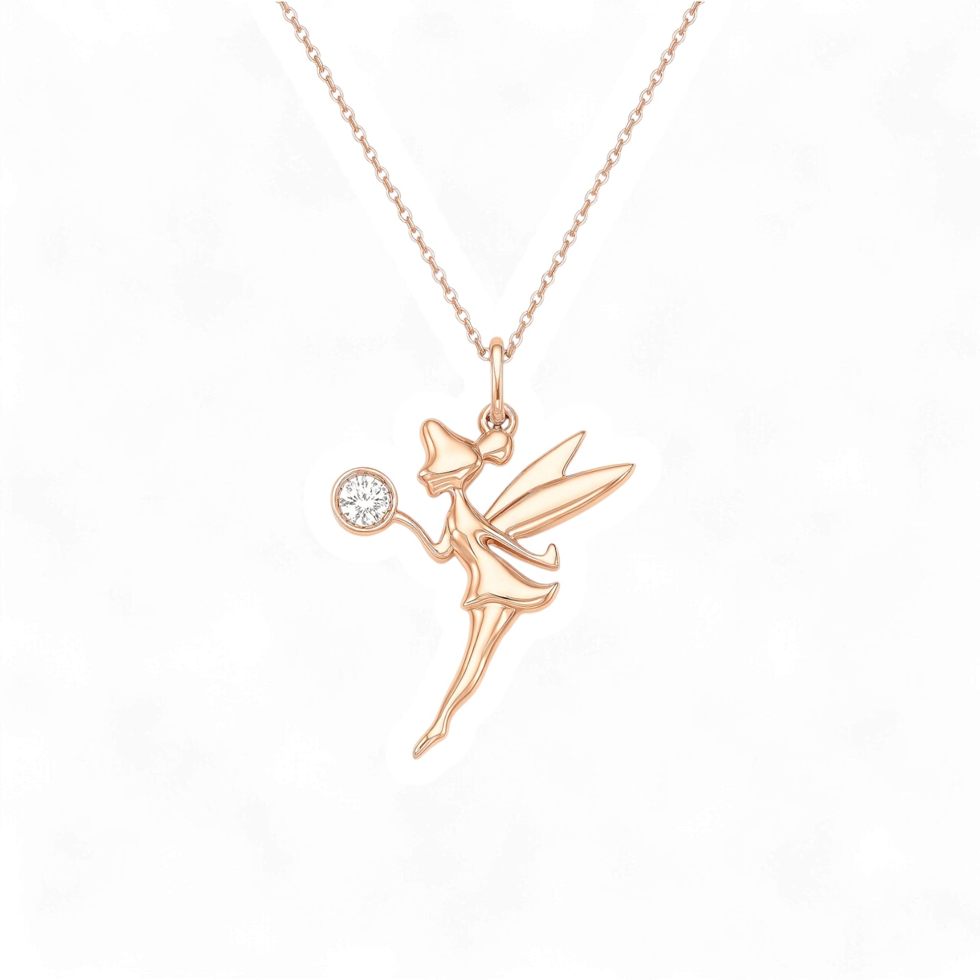 Rose gold fairy pendant necklace on a white background