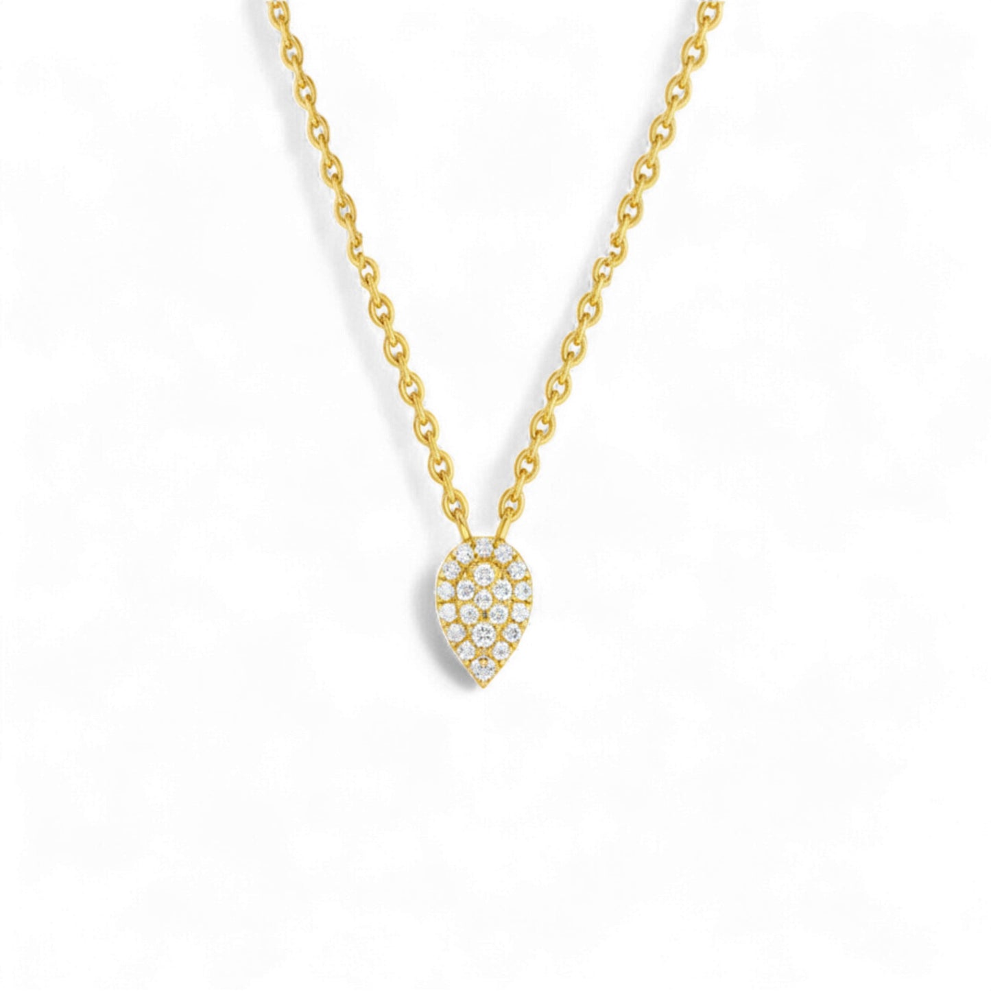 Gold necklace with a heart-shaped diamond pendant on a white background